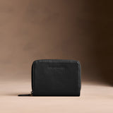 Onyx | Wallet with card and storage pockets on a light brown background