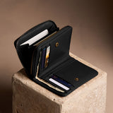 Onyx | Open wallet with card and storage pockets on a light brown background