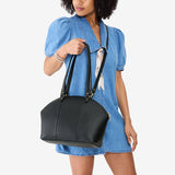 Black Large | Model holding a half circle crossbody bag with handles and removable crossbody strap 