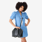 Black Large | Model holding a half circle crossbody bag with handles and removable crossbody strap 