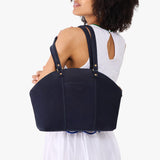 Velvet Blue Large | Model holding a half circle crossbody bag with handles and removable crossbody strap