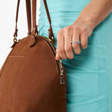 Wildwood Large | Model holding a half circle crossbody bag with handles and removable crossbody strap