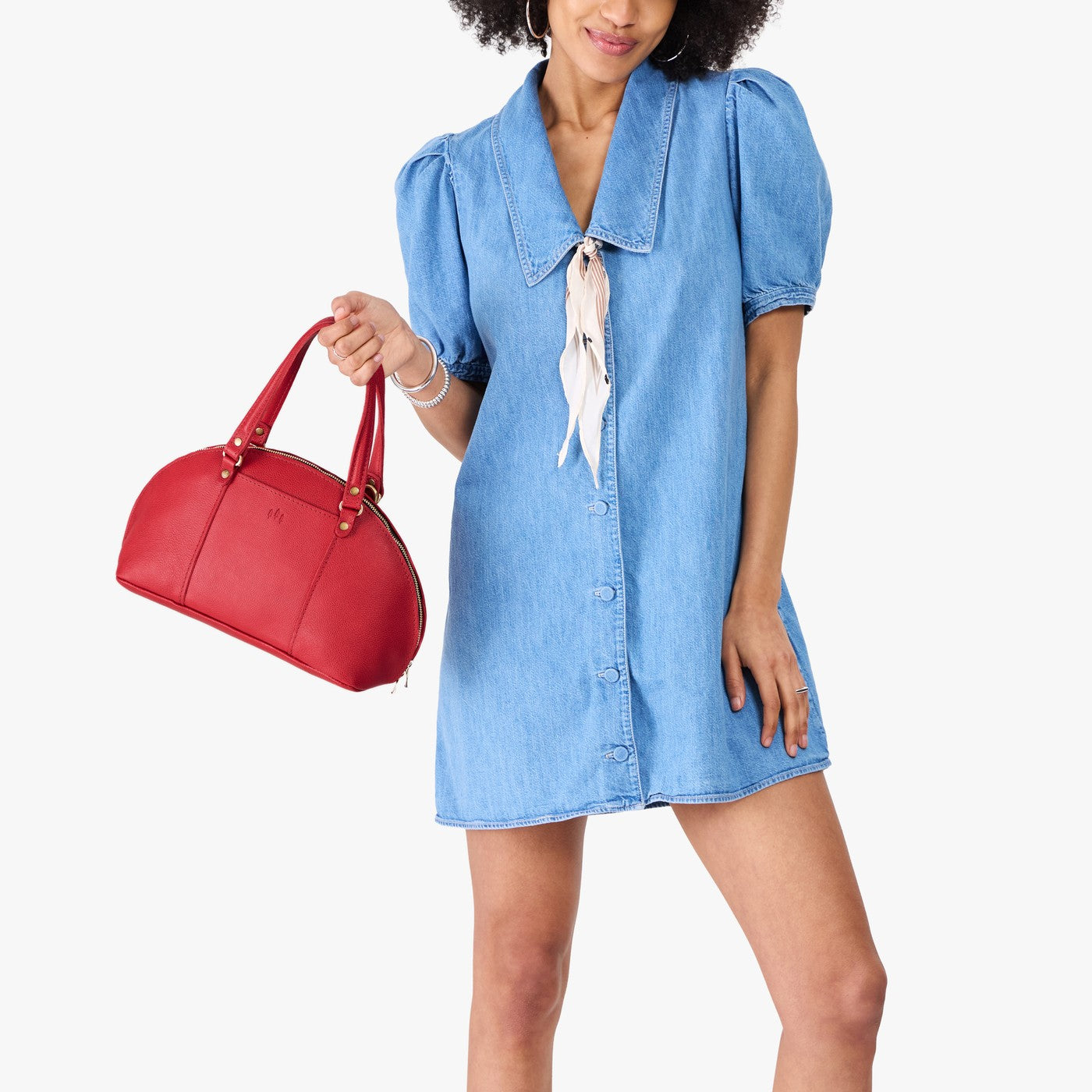 Cherry*Small | Model holding a half circle crossbody bag with handles and removable crossbody strap 