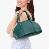 Sea Glass Small | Model holding a half circle crossbody bag with handles and removable crossbody strap