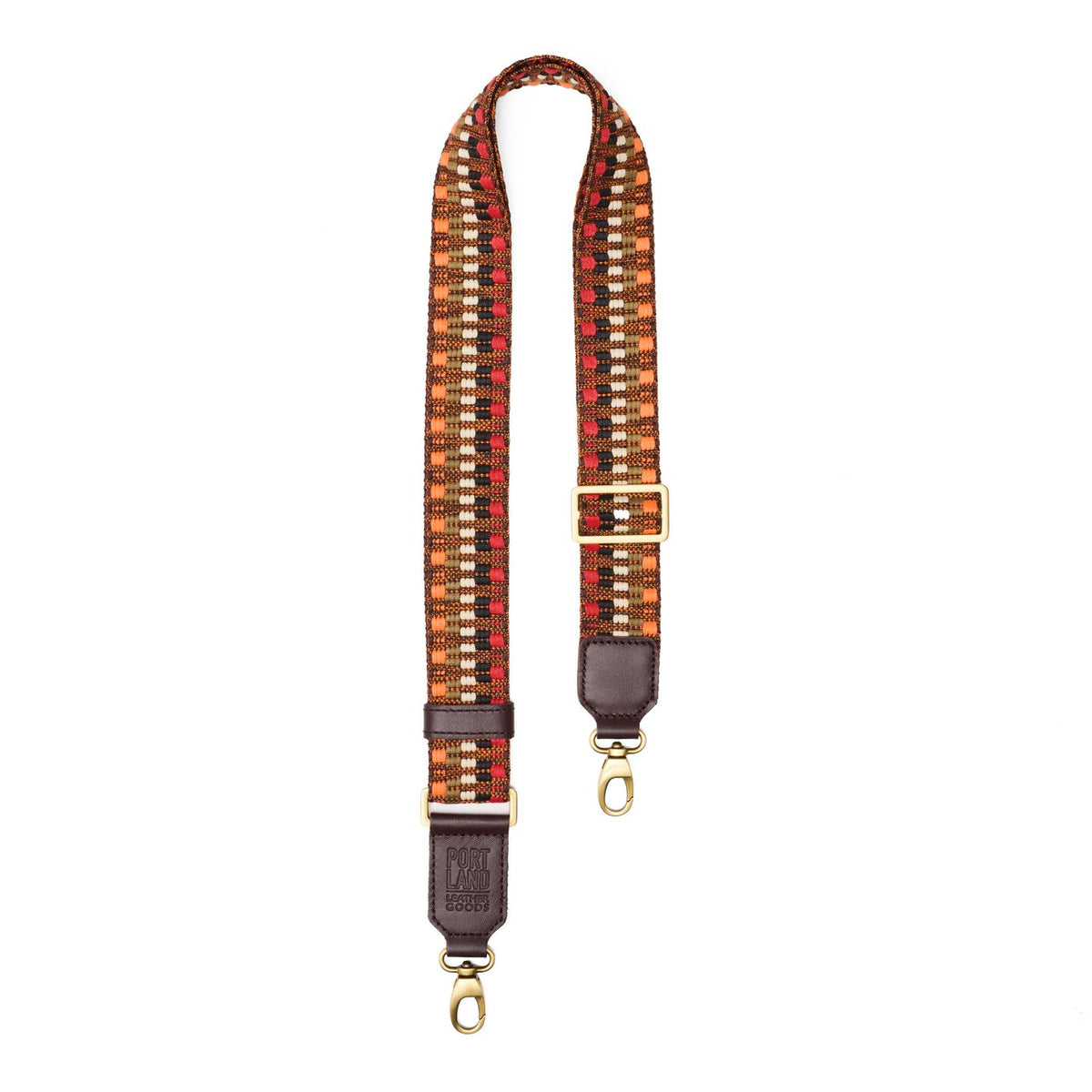 Wild Spice | Patterned fabric and leather strap on a white background 
