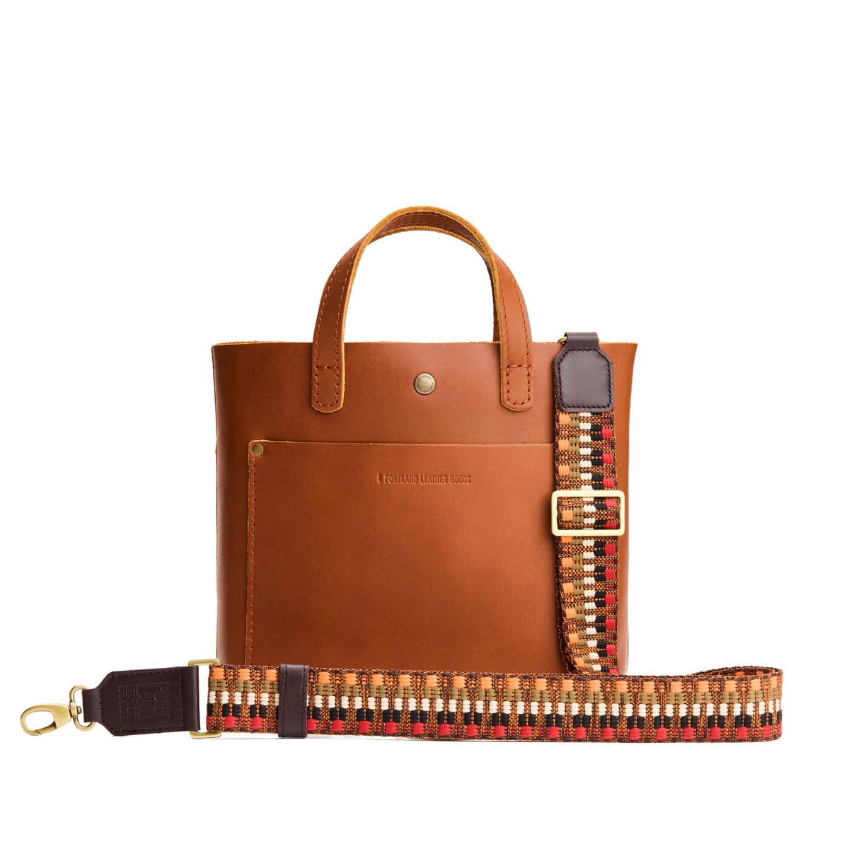 Wild Spice | Patterned fabric and leather strap on a white background 