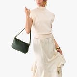 Evergreen | Model carrying petite bean shaped shoulder bag with a zipper closure