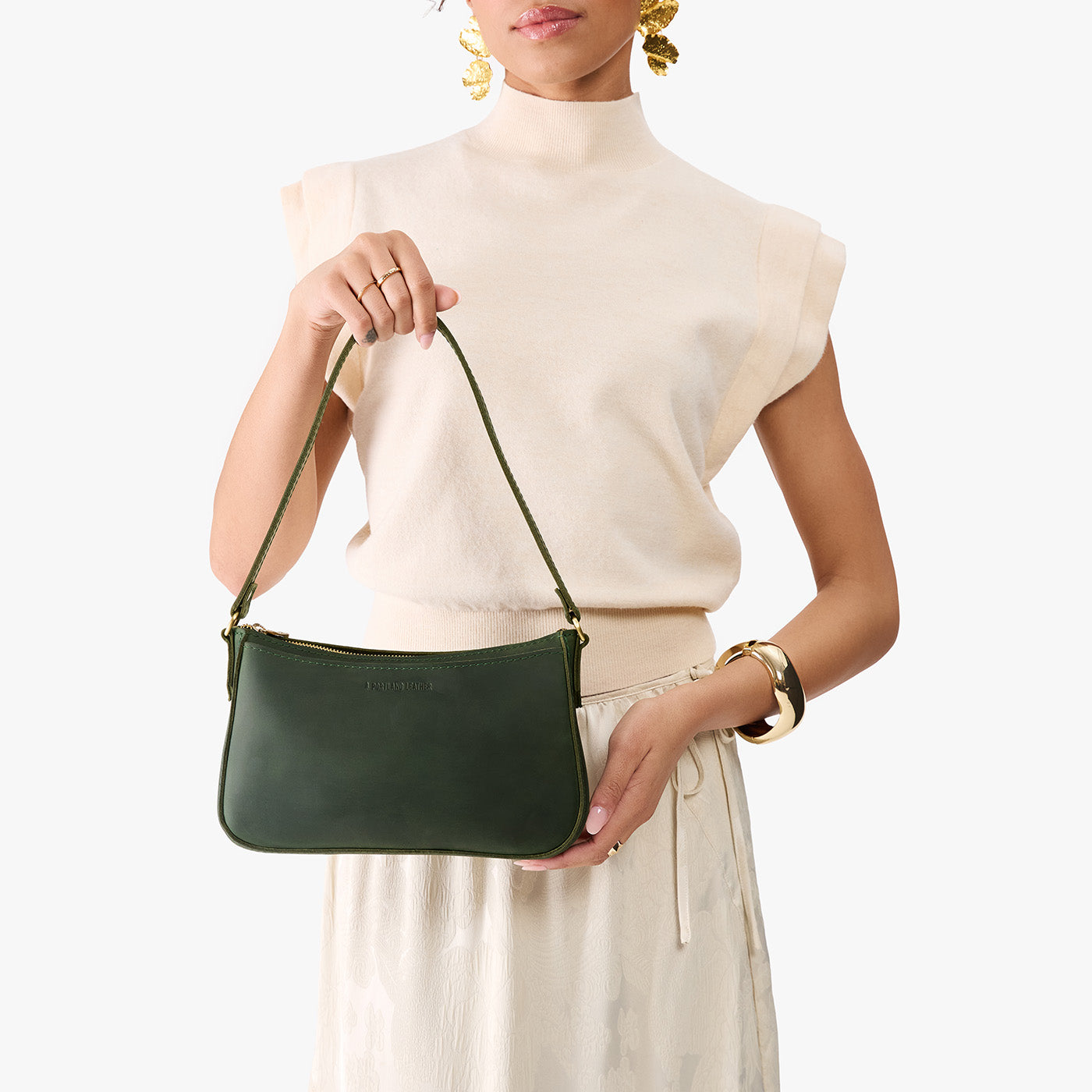 Evergreen | Model carrying petite bean shaped shoulder bag with a zipper closure