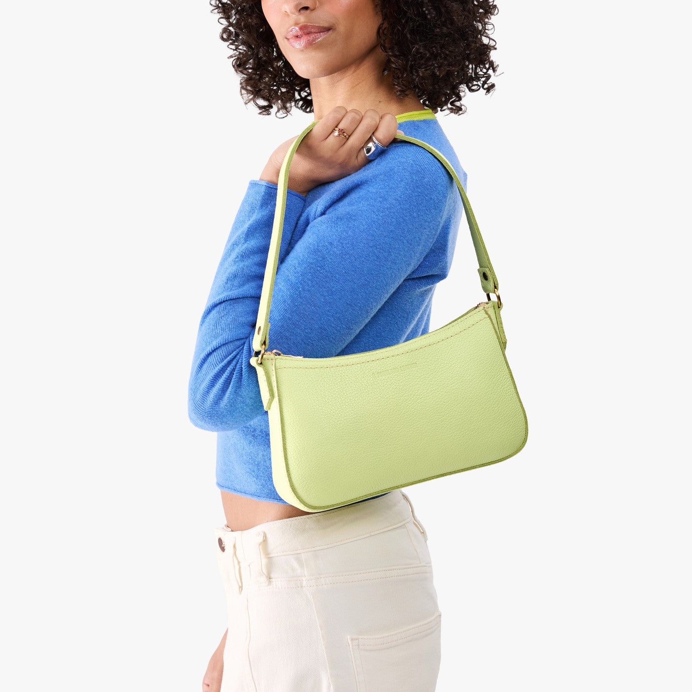 Shadow Lime | Model carrying petite bean shaped shoulder bag with a zipper closure