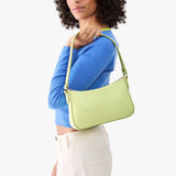Shadow Lime | Model carrying petite bean shaped shoulder bag with a zipper closure