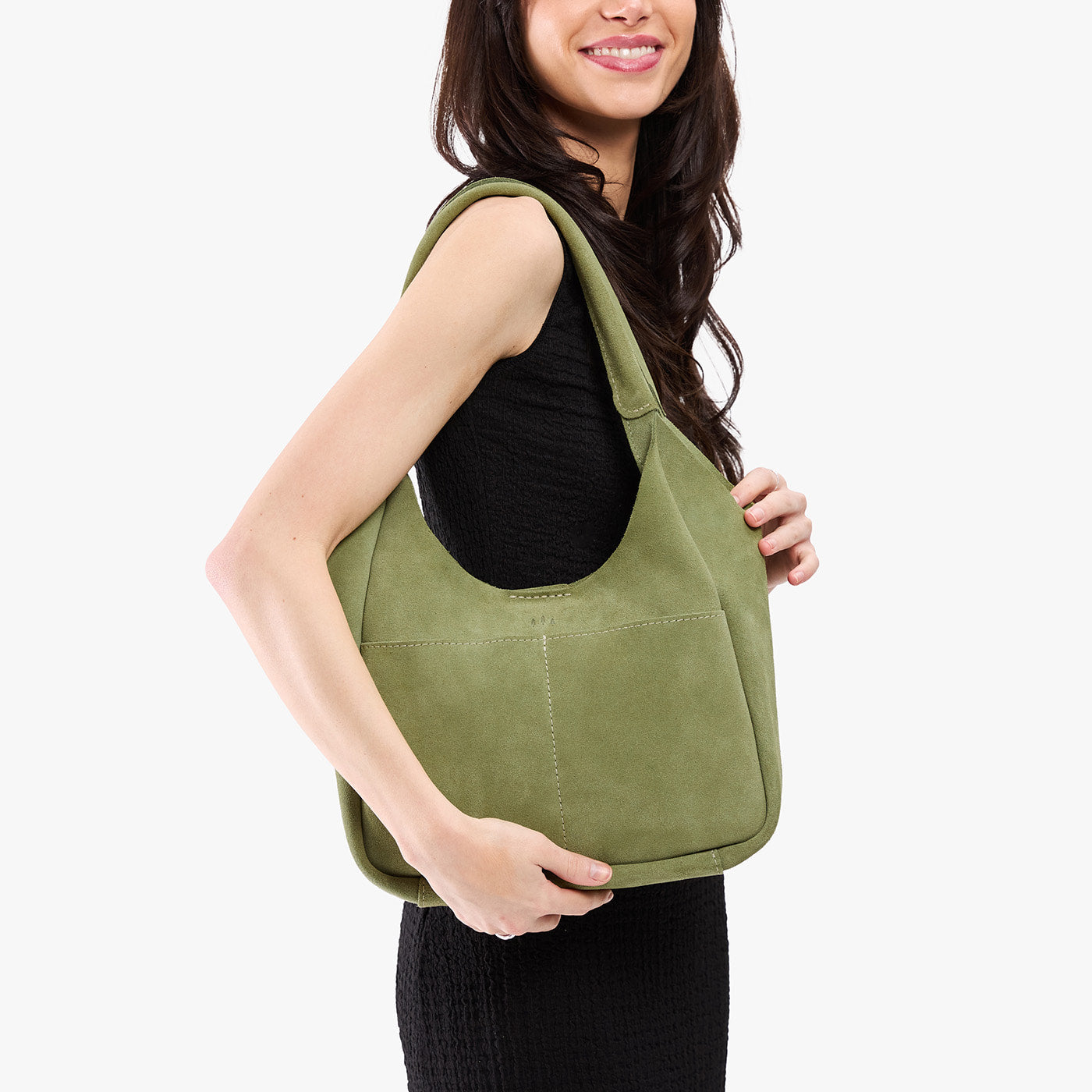 Laurel*Large | A model holding a u-shaped, flat-bottomed leather shoulder bag with two outside pockets