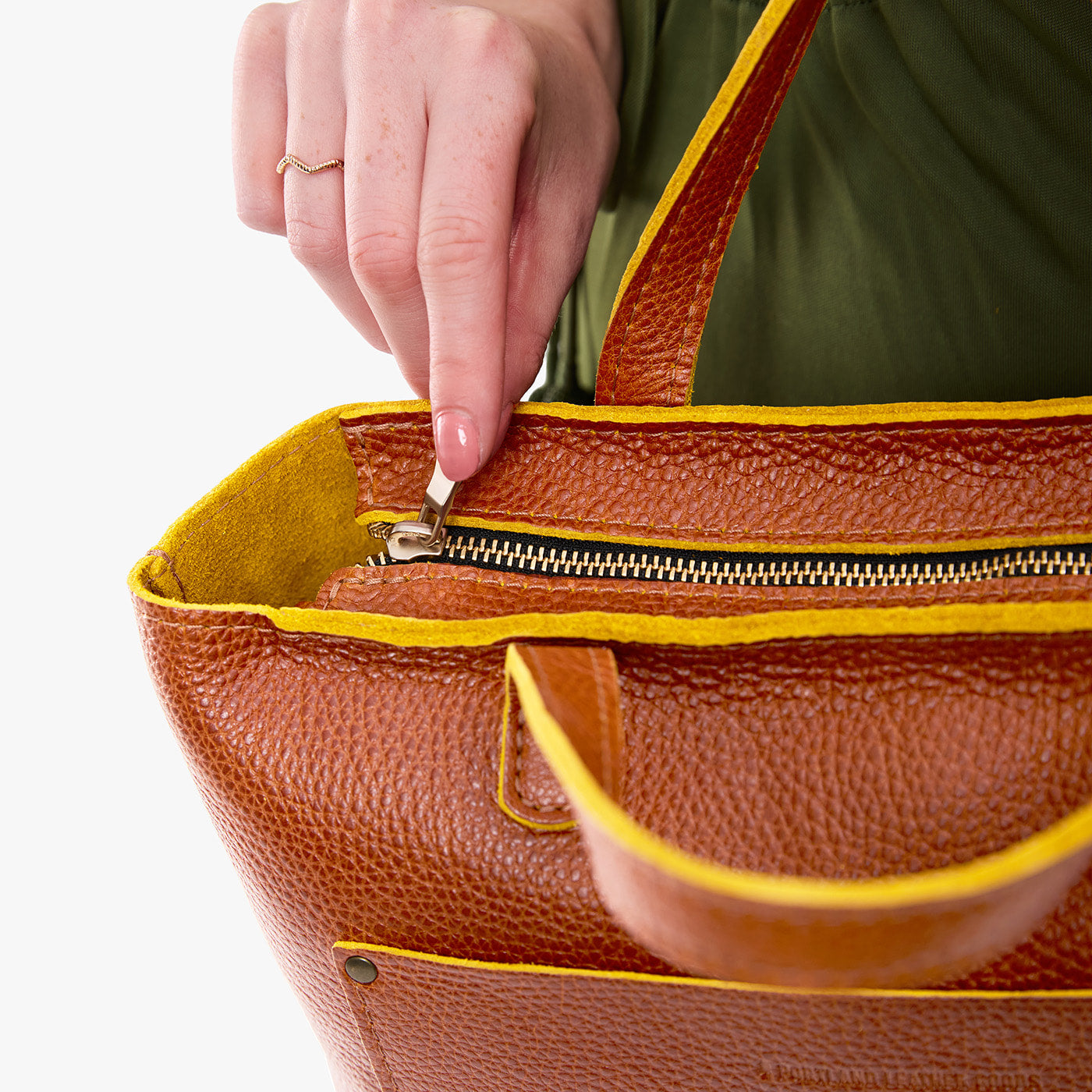 Sienna*Zipper | Model holding midsize crossbody tote with handles and a pocket