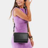 Black Medium | Model Holding Leather Crossbody Bag with Magnetic Messenger Bag Closure