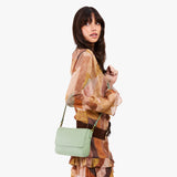 Pistachio Medium | Model Wearing Small Leather Crossbody Bag with Magnetic Messenger Bag Closure