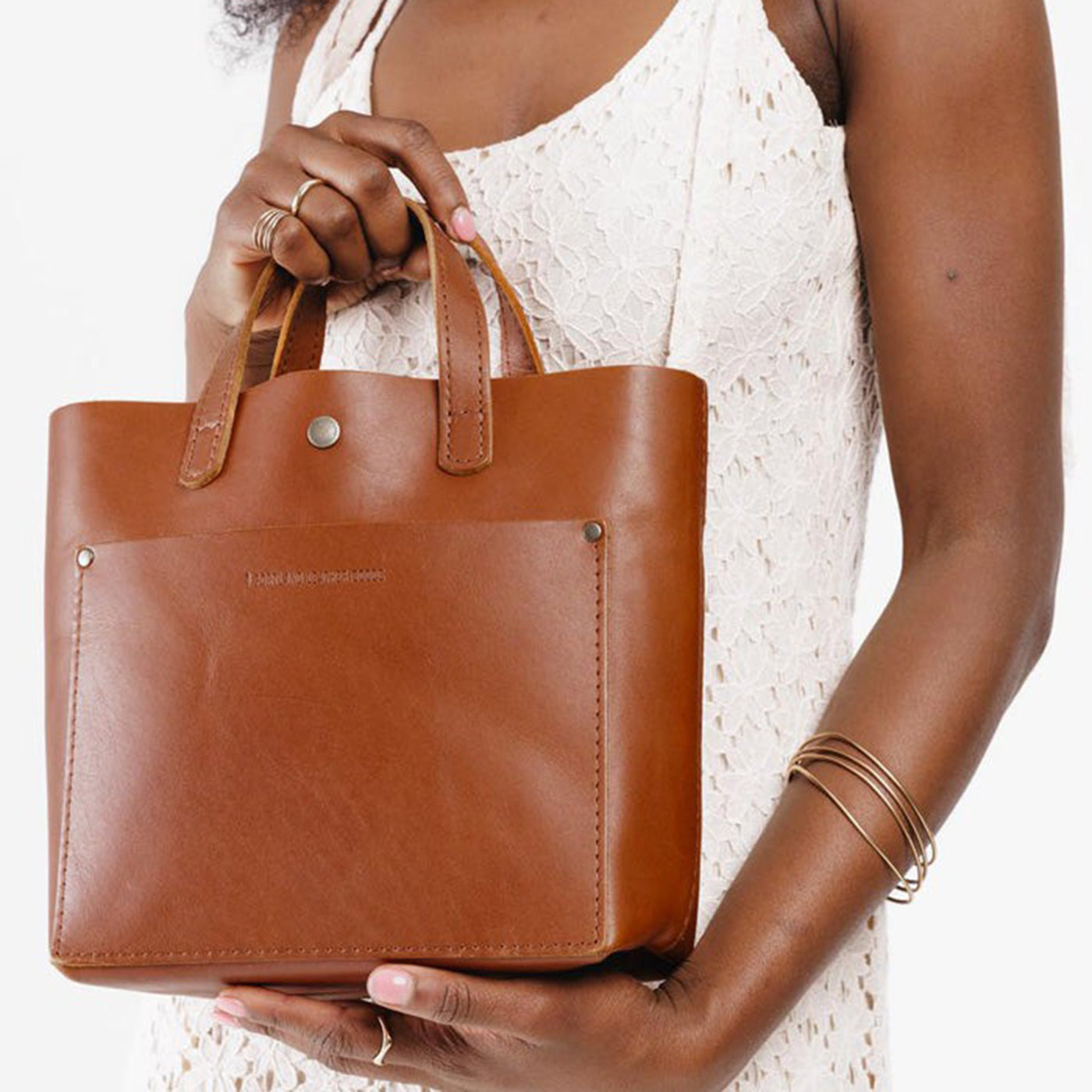 Model holding honey mini crossbody tote