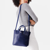 Cobalt Classic | Model wearing crossbody tote bag with snap closure and front pocket
