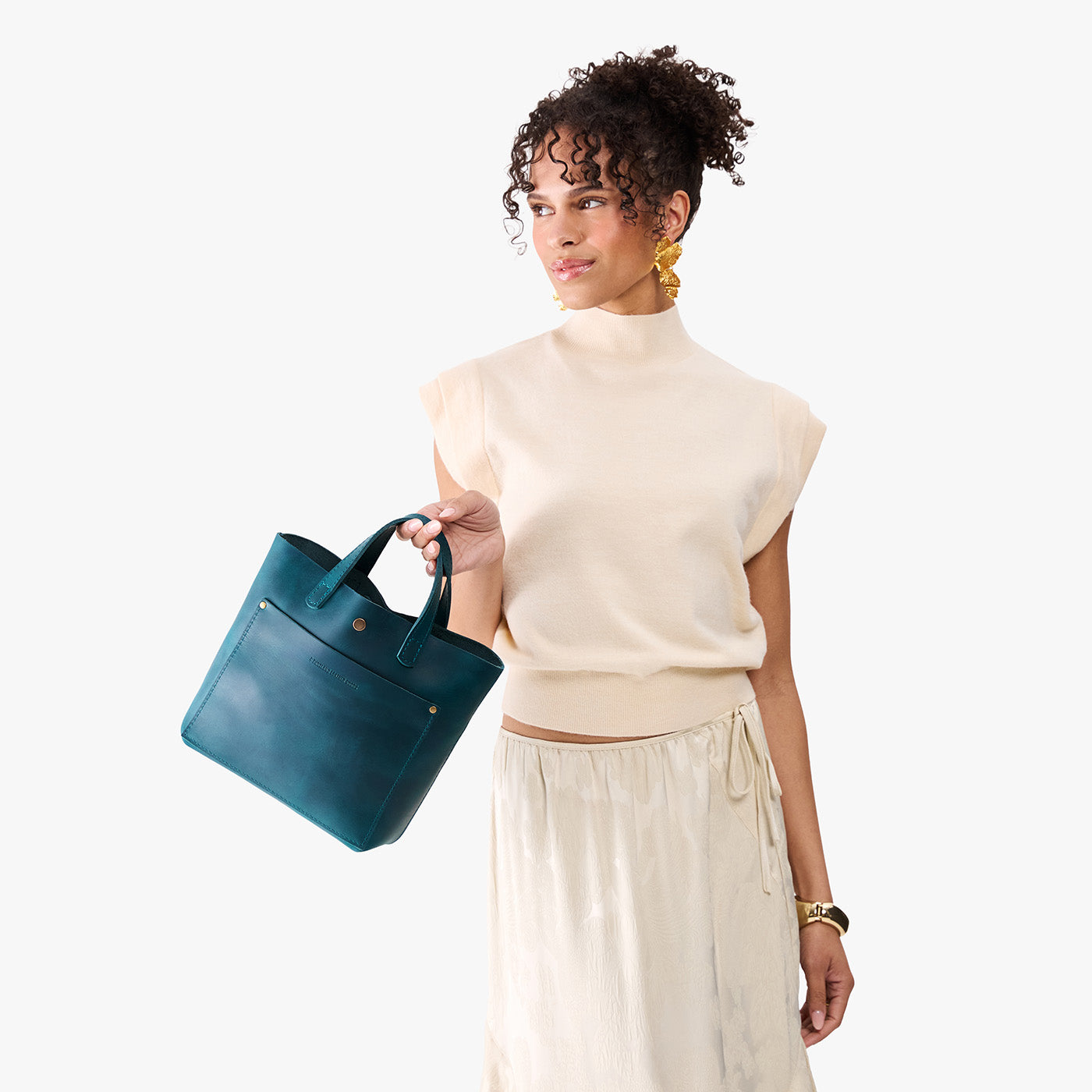 Westward Blue*Classic | Model holding crossbody tote bag with snap closure and front pocket