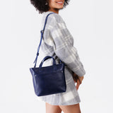 Cobalt Zipper | Model wearing crossbody tote bag with zipper closure and front pocket