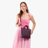 Larkspur Zipper | Model carrying crossbody tote bag with snap closure and front pocket