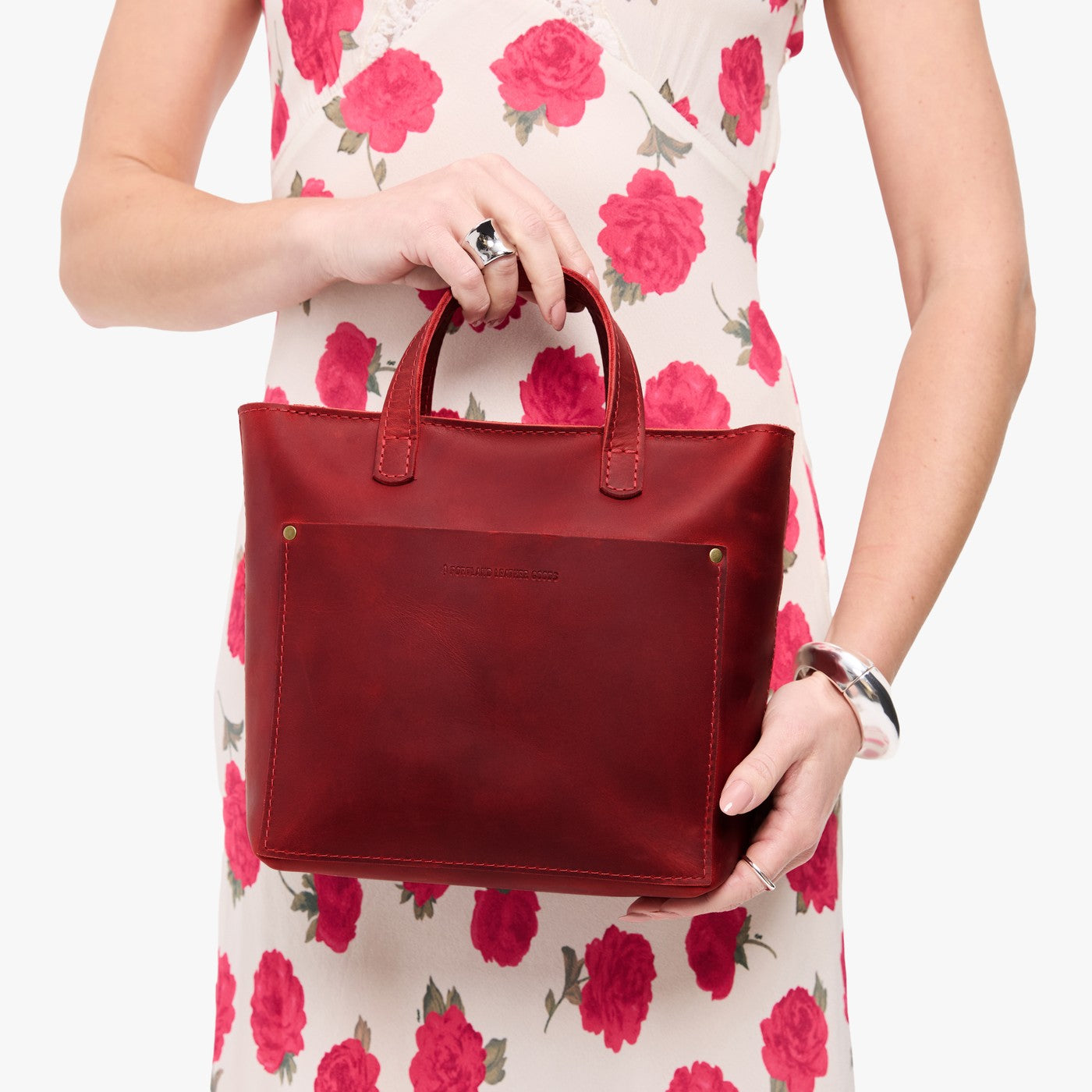 Phoenix*Zipper | Model holding crossbody tote bag with zipper closure and front pocket