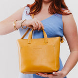 Sunflower Zipper | Model holding crossbody tote bag with zipper closure and front pocket