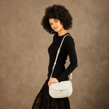 Bone Large | Model wearing a leather Crossbody with a flap and magnetic closure