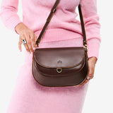 Chocolate Brown Large | Model wearing a leather Crossbody with a flap and magnetic closure