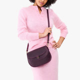 Larkspur Large | Model wearing a leather Crossbody with a flap and magnetic closure