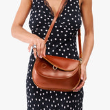 Madrone Large | Model wearing a leather Crossbody with a flap and magnetic closure