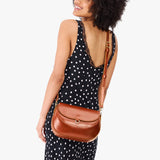 Madrone Large | Model wearing a leather Crossbody with a flap and magnetic closure
