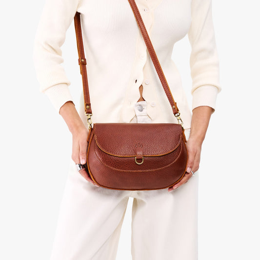 Nutmeg*Large | Model wearing a leather Crossbody with a flap and magnetic closure