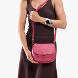Wild Rose Small | Model wearing a petite leather Crossbody with a flap and magnetic closure