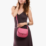 Wild Rose Small | Model wearing a petite leather Crossbody with a flap and magnetic closure