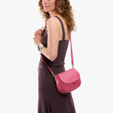 Wild Rose Small | Model wearing a petite leather Crossbody with a flap and magnetic closure