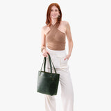 Evergreen Medium Classic | Model wearing leather tote bag with riveted straps and exterior key loop