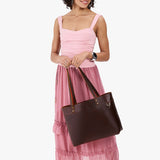Coldbrew Large Classic | Model wearing leather tote bag with riveted straps and exterior key loop