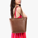 Asheville Medium Zipper | Model wearing leather tote bag with riveted straps and exterior key loop