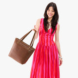 Asheville Medium Zipper | Model wearing leather tote bag with riveted straps and exterior key loop