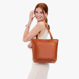 Sienna Medium Zipper | Model wearing leather tote bag with riveted straps and exterior key loop