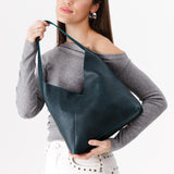 Boreal Large | Model holding mid-size shoulder bag with magnetic snap closure