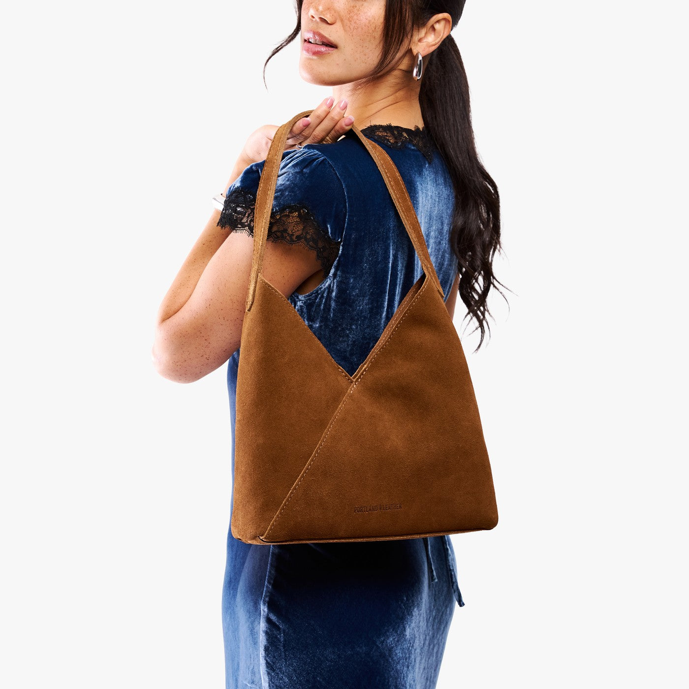 Model carrying mid-size shoulder bag with magnetic snap closure