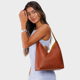 Sienna Large | Model wearing mid-size shoulder bag with adjustable strap and magnetic snap closure