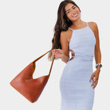 Sienna Large | Model holding mid-size shoulder bag with adjustable strap and magnetic snap closure