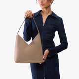 Stone Large | Model wearing mid-size shoulder bag with magnetic snap 