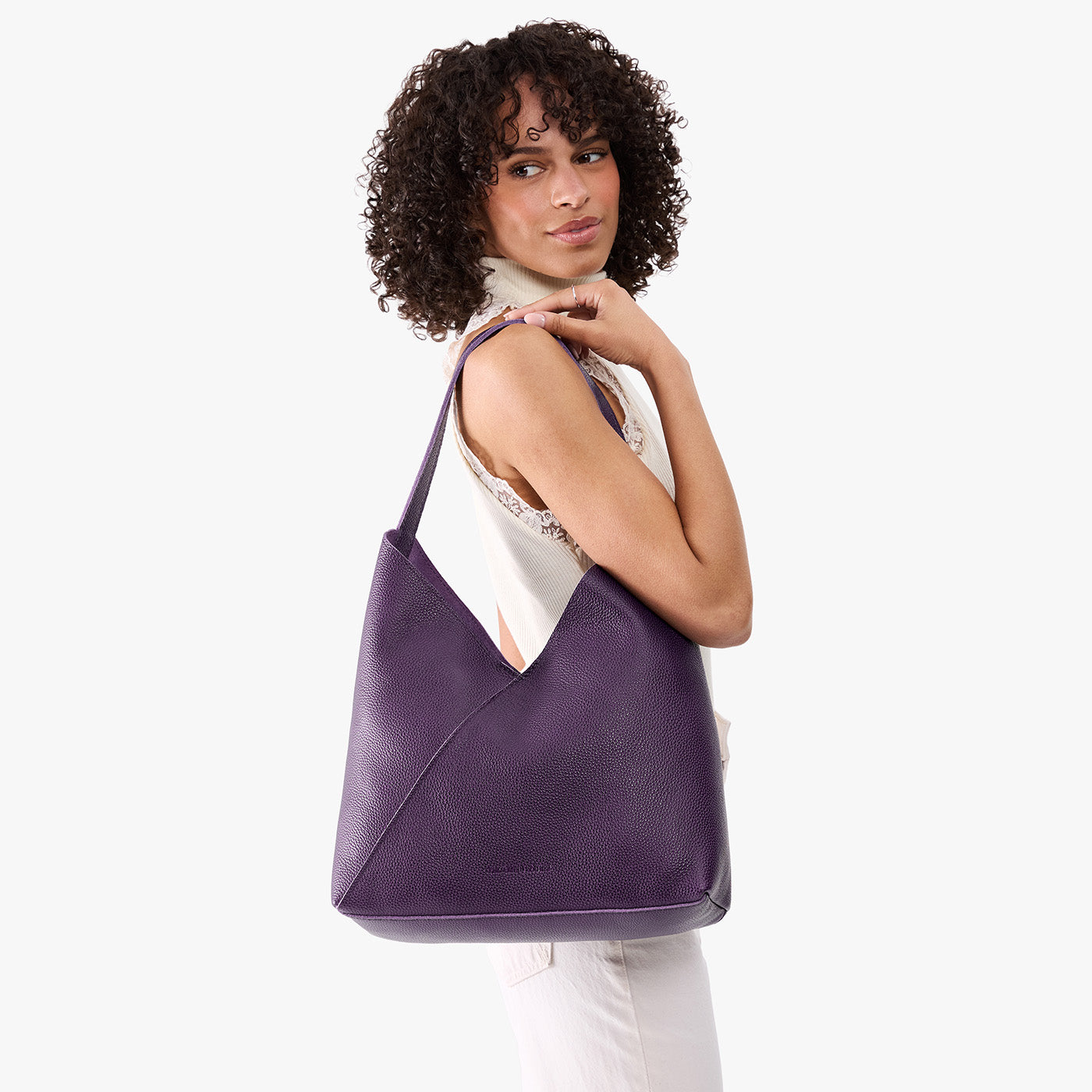 Empire*Oversized | Model wearing large shoulder bag with adjustable strap and magnetic snap closure