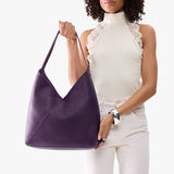 Empire Oversized | Model wearing large shoulder bag with adjustable strap and magnetic snap closure