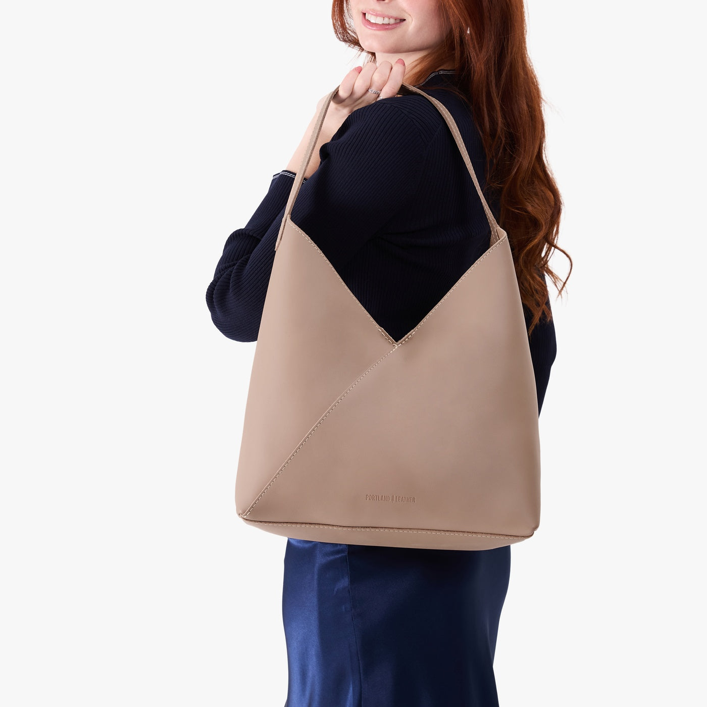 Stone*Oversized | Model wearing large shoulder bag with adjustable strap and magnetic snap closure