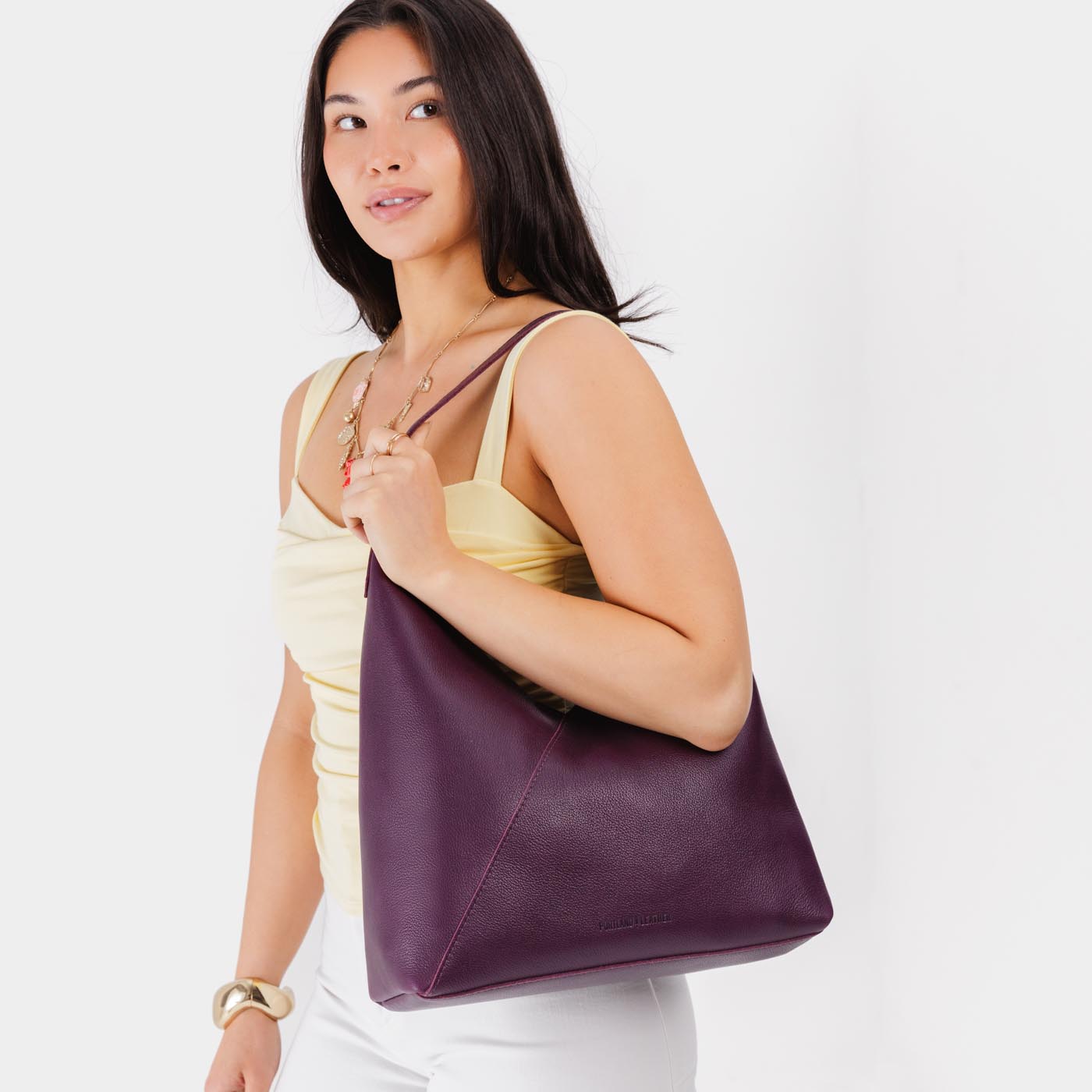 Plum*Oversized | Model wearing large shoulder bag with magnetic snap closure