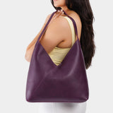 Plum Oversized | Model wearing large shoulder bag with magnetic snap closure