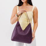 Plum Oversized | Model wearing large shoulder bag with magnetic snap closure